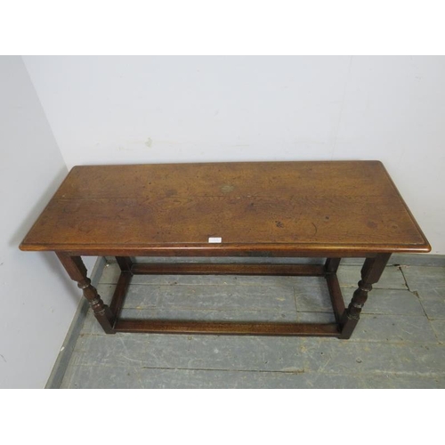 815 - A 19th century oak serving table, on turned and block supports with stretchers. 
H68cm W129cm D49cm ... 