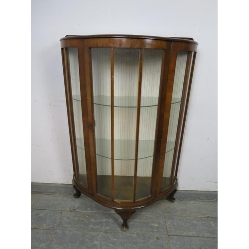 817 - An Art Deco Period demi-lune glazed display cabinet, having two loose glass shelves, on ogee support... 