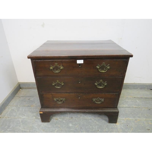 818 - A George III straight front mahogany chest of small proportions, housing three long drawers with bra... 