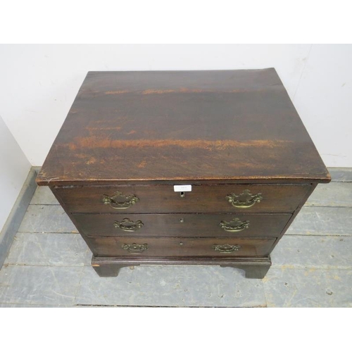 818 - A George III straight front mahogany chest of small proportions, housing three long drawers with bra... 