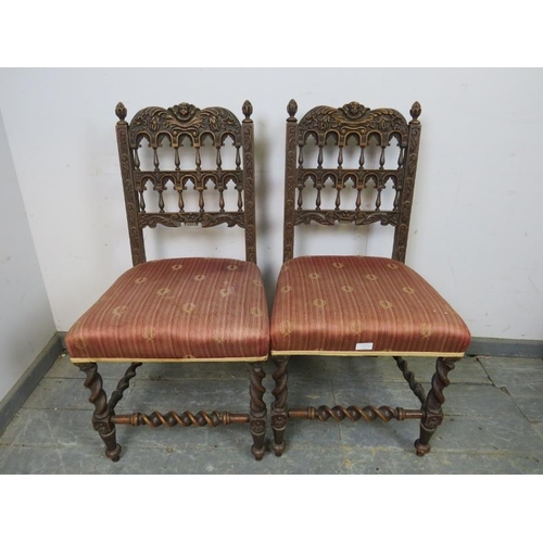 819 - A pair of 19th century Gothic Revival oak side chairs, the ornately carved backs with turned spindle... 