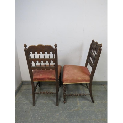 819 - A pair of 19th century Gothic Revival oak side chairs, the ornately carved backs with turned spindle... 