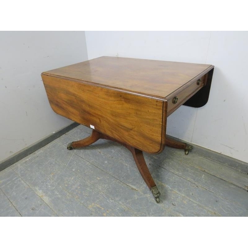 820 - A good Regency Period mahogany Pembroke table, having long drawers to either end with pressed brass ... 