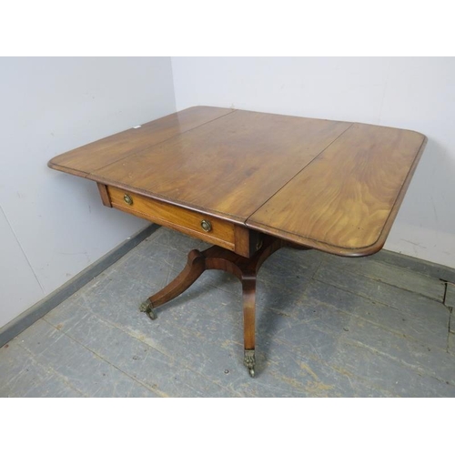 820 - A good Regency Period mahogany Pembroke table, having long drawers to either end with pressed brass ... 