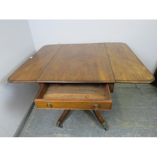 820 - A good Regency Period mahogany Pembroke table, having long drawers to either end with pressed brass ... 