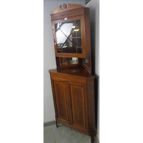 821 - An Edwardian mahogany tall corner cupboard, crossbanded and parquetry strung, the top section with a... 