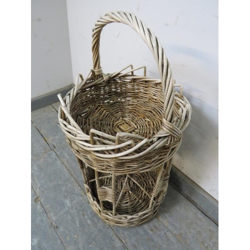 825 - A vintage French two-tier wicker picnic basket, the top section with woven gallery above a wine bott... 