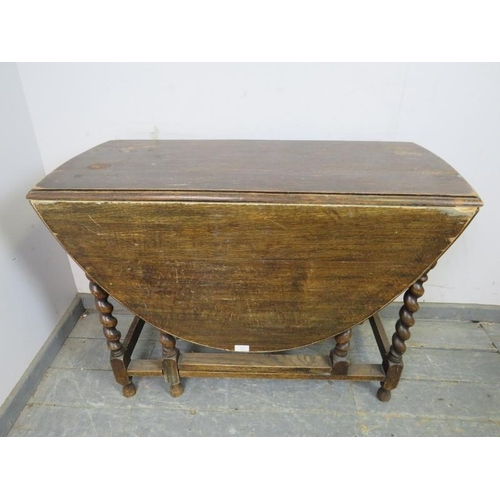 827 - An antique oak oval gate-leg table, on barley twist supports with stretchers. 
H72cm W102cm D47-133c... 