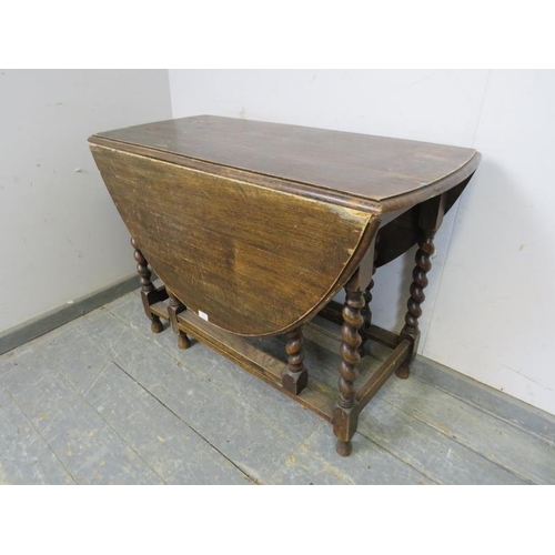 827 - An antique oak oval gate-leg table, on barley twist supports with stretchers. 
H72cm W102cm D47-133c... 