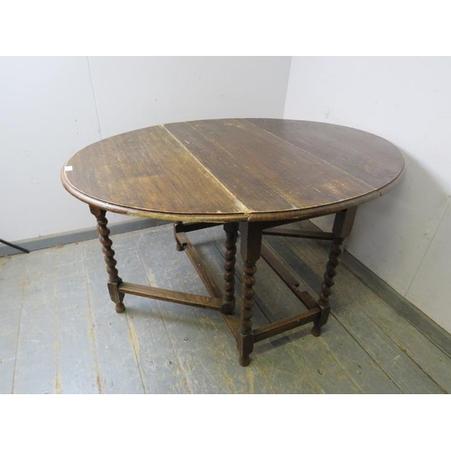 827 - An antique oak oval gate-leg table, on barley twist supports with stretchers. 
H72cm W102cm D47-133c... 