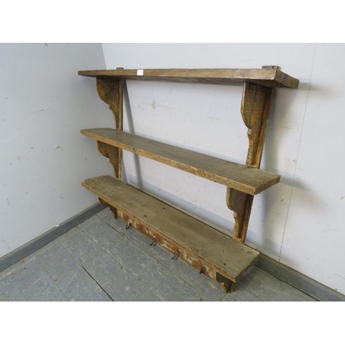 830 - A rustic Continental antique pine wall-mounting set of three open shelves with shaped brackets under... 