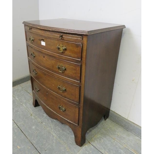 832 - A vintage mahogany bow fronted chest in the Georgian taste, having a pull-out brushing slide above f... 