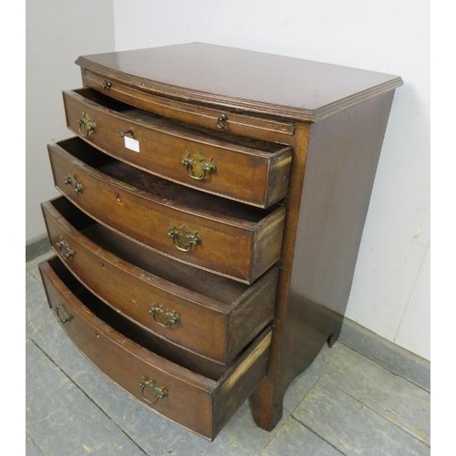 832 - A vintage mahogany bow fronted chest in the Georgian taste, having a pull-out brushing slide above f... 