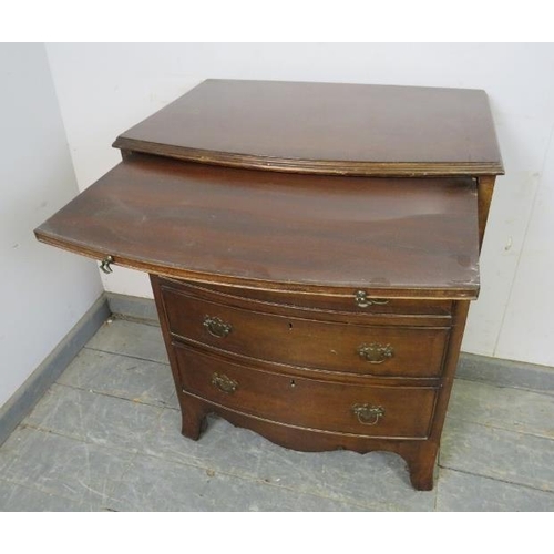 832 - A vintage mahogany bow fronted chest in the Georgian taste, having a pull-out brushing slide above f... 