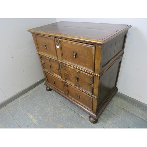 839 - A 17th century and later oak chest housing three long drawers with split moulded geometric decoratio... 