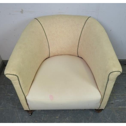 840 - A 19th century tub chair upholstered in calico with green piping, on ball feet with steel castors. 
... 