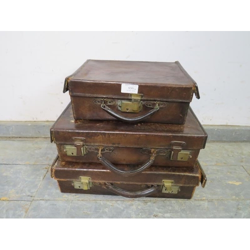 850 - Three graduated antique leather luggage cases of good patina, with brass fittings. 
Largest H11cm W4... 