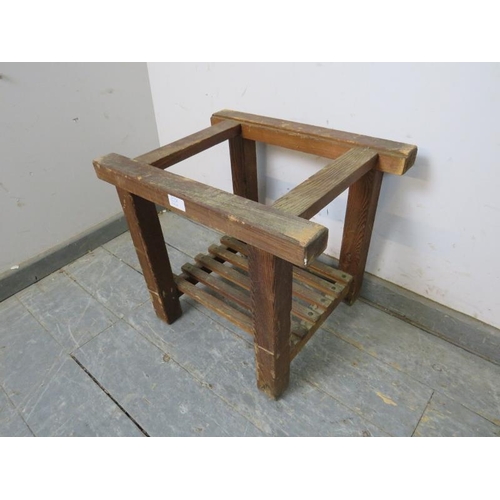 850A - A vintage pine freestanding luggage rack, with slatted shelf below, on square supports. 
H43cm W50cm... 