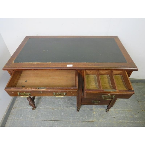 857 - An Edwardian mahogany kneehole desk, housing a configuration of five graduated oak-lined drawer with... 