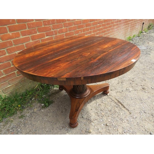 863 - A 19th century rosewood tilt-top circular breakfast table, above a tapering plain pedestal with carv... 