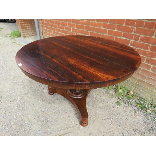 863 - A 19th century rosewood tilt-top circular breakfast table, above a tapering plain pedestal with carv... 