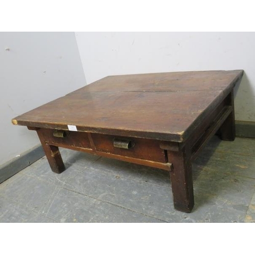 869 - A vintage Japanese fruitwood low coffee table, housing two short drawers with brass scalloped handle... 