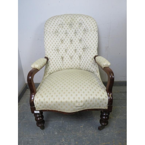 872 - A Victorian mahogany open-sided button backed armchair, upholstered in patterned cream material, on ... 