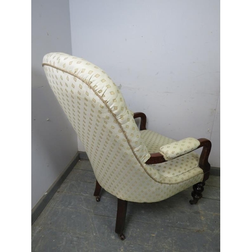 872 - A Victorian mahogany open-sided button backed armchair, upholstered in patterned cream material, on ... 