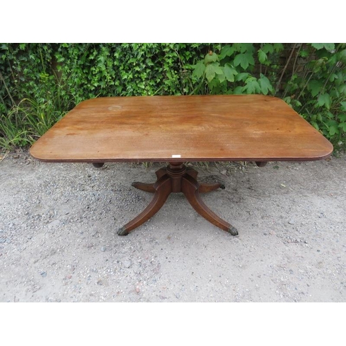 877 - A Regency Period mahogany tilt-top breakfast table, the rectangular top with reeded edge, on a turne... 