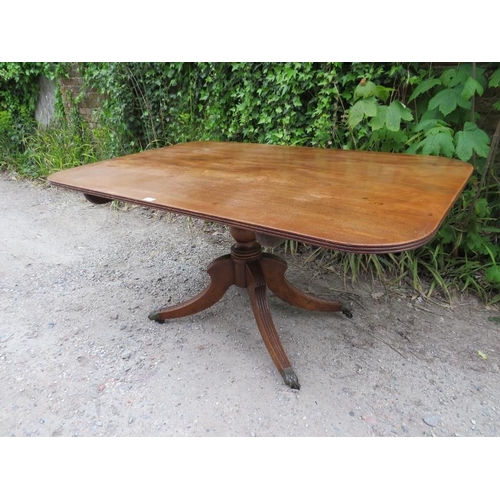 877 - A Regency Period mahogany tilt-top breakfast table, the rectangular top with reeded edge, on a turne... 