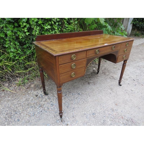 878 - A 19th century mahogany kneehole desk, crossbanded and strung with satinwood, housing a configuratio... 