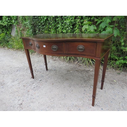 880 - An antique Regency Revival mahogany serpentine fronted serving table, housing three short drawers wi... 