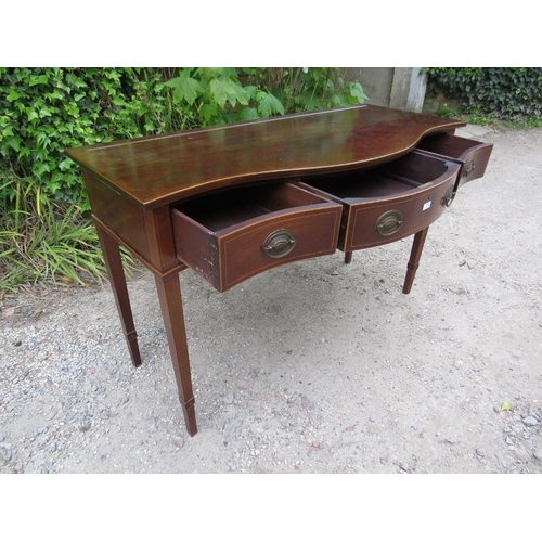 880 - An antique Regency Revival mahogany serpentine fronted serving table, housing three short drawers wi... 