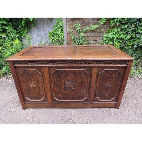 885 - A large antique oak and pitch pine panelled coffer in the 17th century taste, the front with blind f... 