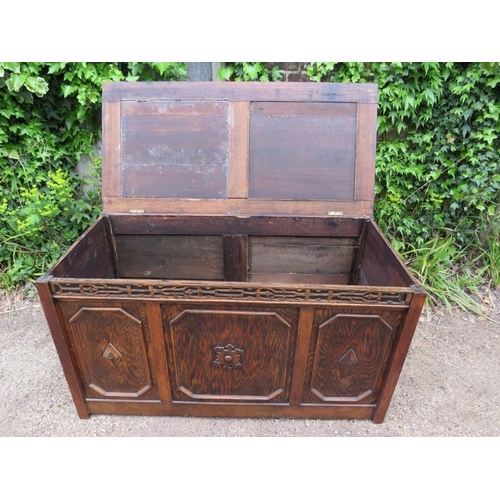 885 - A large antique oak and pitch pine panelled coffer in the 17th century taste, the front with blind f... 