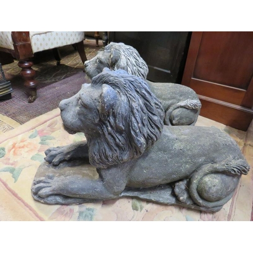 888 - A pair of well rendered reconstituted stone lions passant, on plinth bases. 
H37cm W26cm D64cm (appr... 