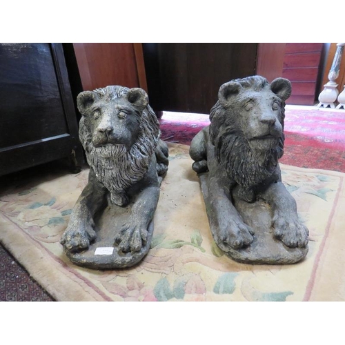 888 - A pair of well rendered reconstituted stone lions passant, on plinth bases. 
H37cm W26cm D64cm (appr... 