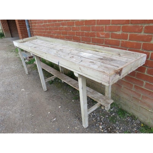 890 - An antique pine potting bench, the galleried planked top on six square supports with stretchers. 
H8... 