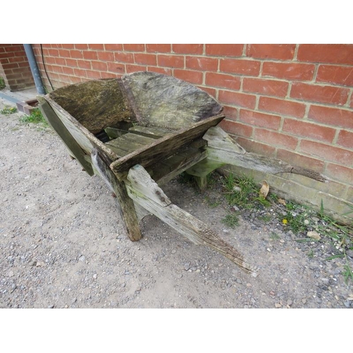 892 - A weathered antique oak garden wheelbarrow/garden planter. 
H58cm W140cm D66cm (approx).
Condition r... 