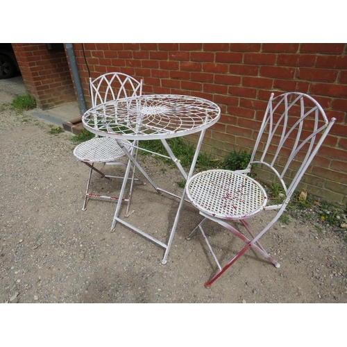 893 - A steel garden set painted white comprising a circular folding table with radial wirework decoration... 