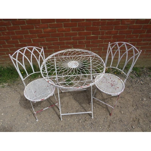 893 - A steel garden set painted white comprising a circular folding table with radial wirework decoration... 