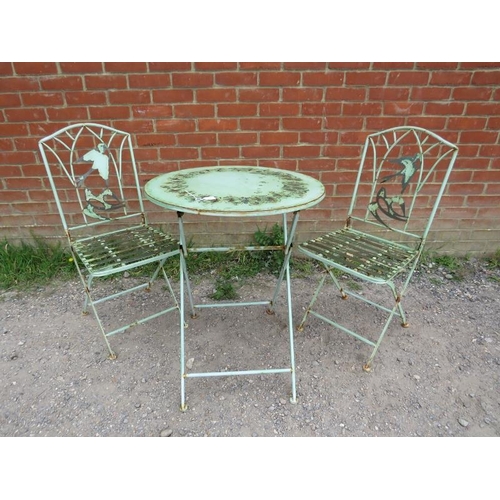 894 - A vintage steel garden set painted green comprising a circular folding table with pierced swallow de... 