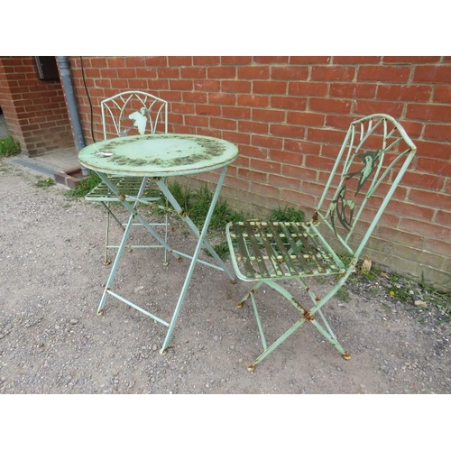 894 - A vintage steel garden set painted green comprising a circular folding table with pierced swallow de... 