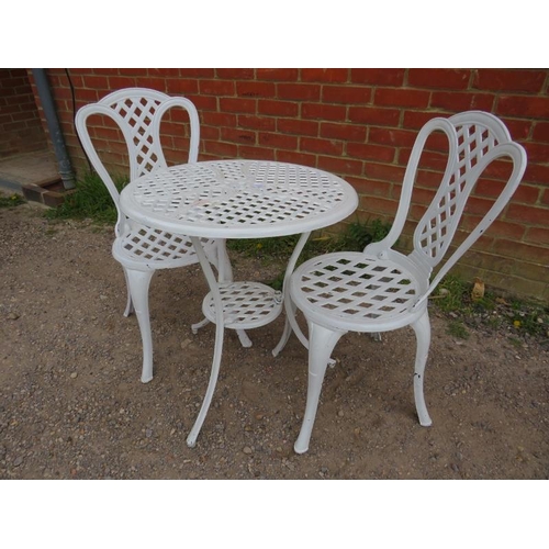 896 - A vintage cast iron 3-piece garden set painted white, comprising a circular two-tier table with latt... 