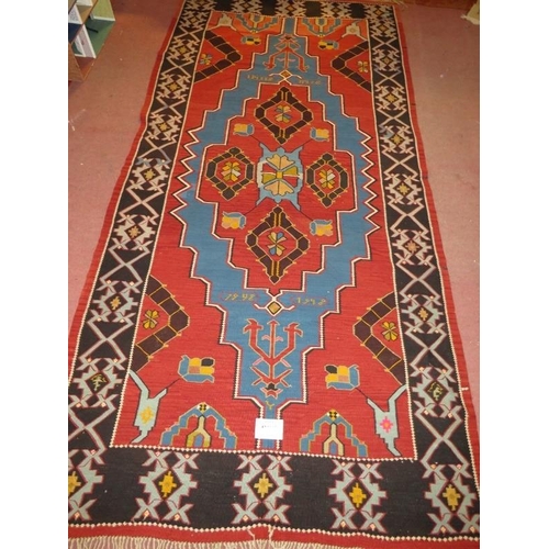 913 - A large 20th century Armenian Kilim rug, vibrant colours, blue on burnt amber field. 340cm x 161cm (... 