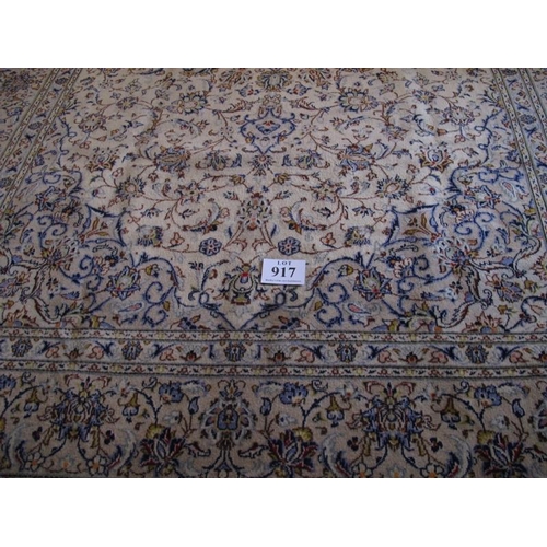 917 - A fine central Persian Kashan carpet.  A 16 point central motif on cream ground, surrounded by flowe... 