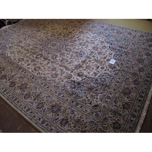 917 - A fine central Persian Kashan carpet.  A 16 point central motif on cream ground, surrounded by flowe... 