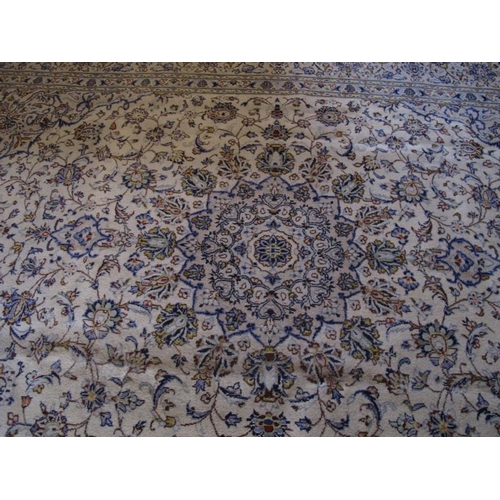 917 - A fine central Persian Kashan carpet.  A 16 point central motif on cream ground, surrounded by flowe... 