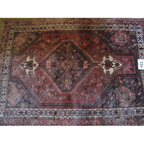 922 - A 20th Century Qashqai rug.  Central pointed medallion on a red/pink ground bordered in cream.  158 ... 