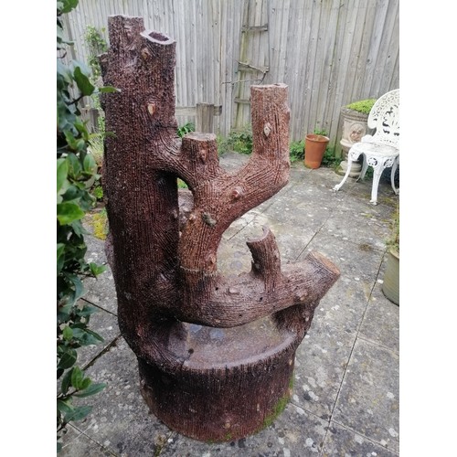 886 - A large 19th century naturalistic stoneware garden seat, modelled as a tree stump with backrest in t... 